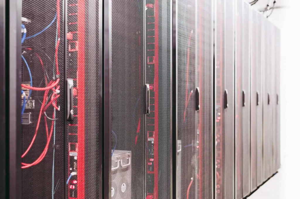 Server racks with network cables inside modern data center facility